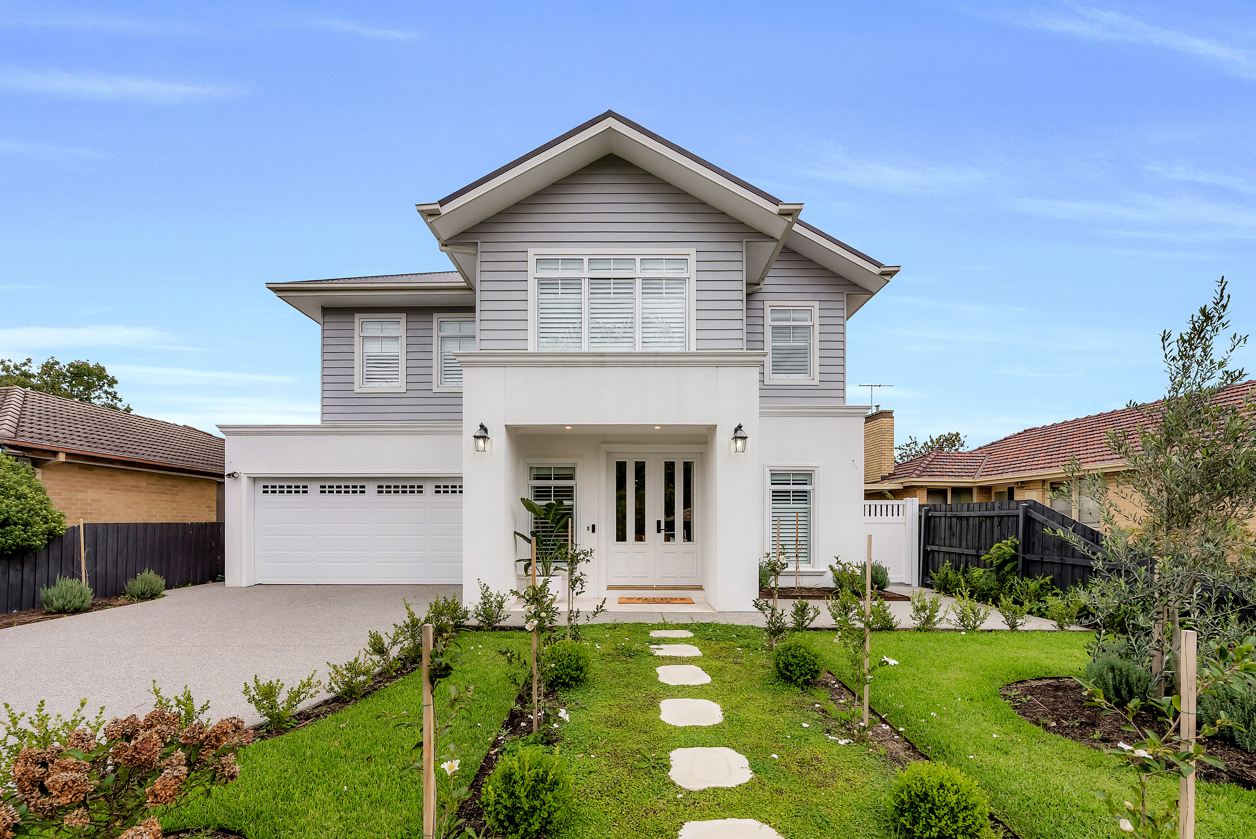 Hamptons-style two-storey home exterior with weatherboard cladding