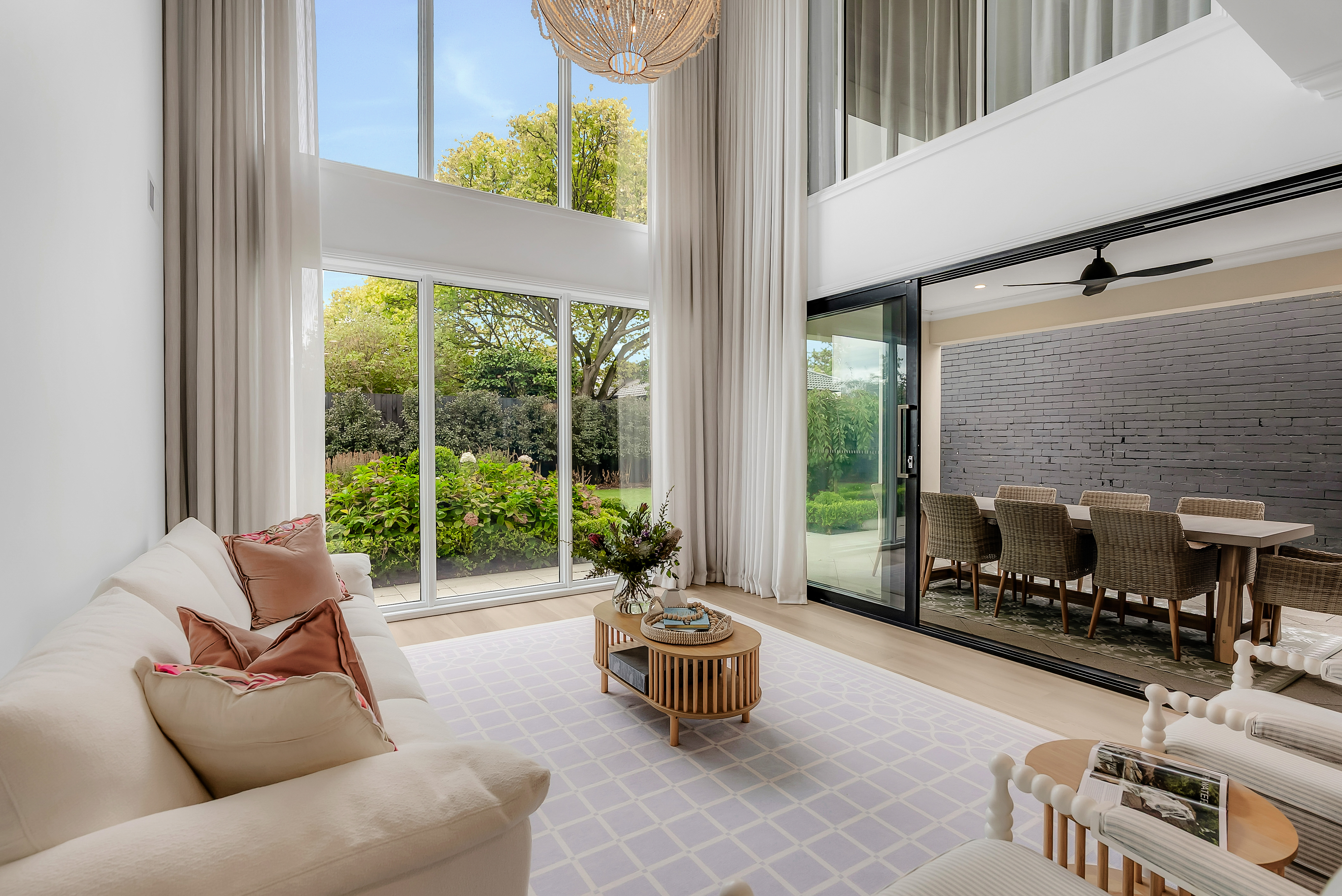 Bright open living room with full-height windows and natural light